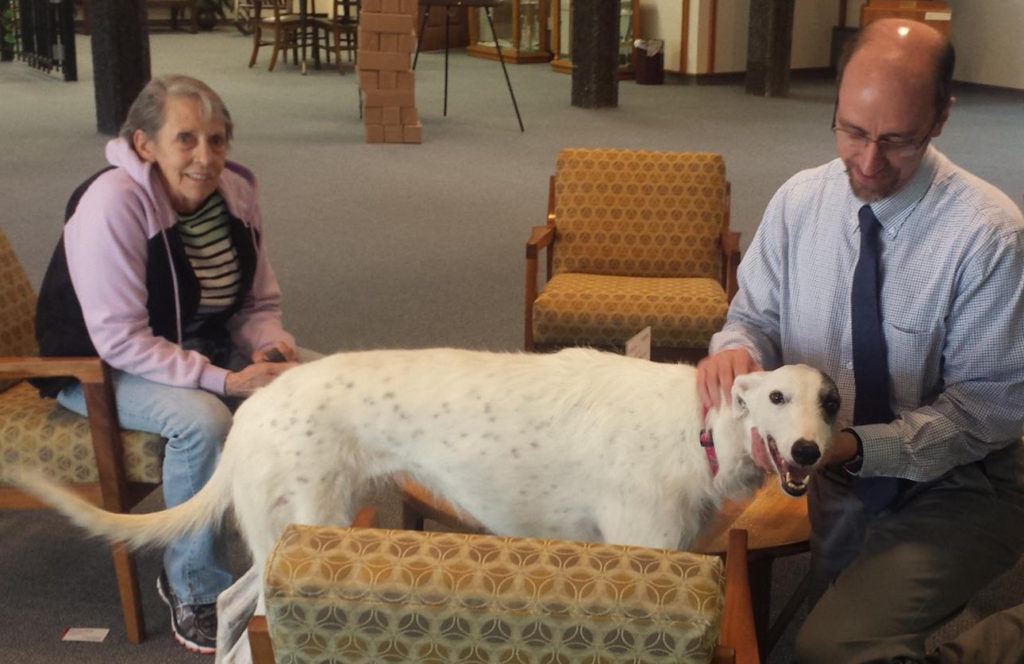 Alliance of Therapy Dogs volunteer Charlie Vogel, her dog Annie, and Casper College Library Director Brad Matthies