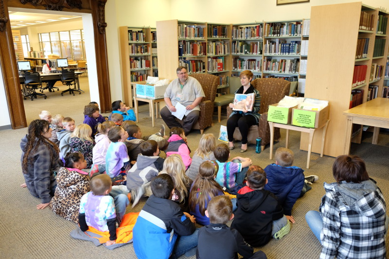 The Wyoming State Library's Thomas Ivie and Angela Wolff reading to a group.