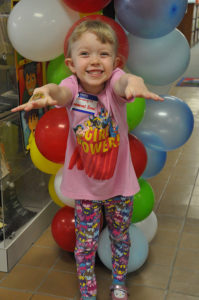 Little girl in front of balloons at Uinta County Library